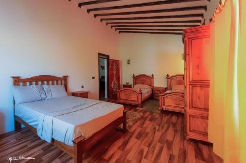 a bedroom with a bed and two wooden furniture at Riad Dreams chaouen in Chefchaouene