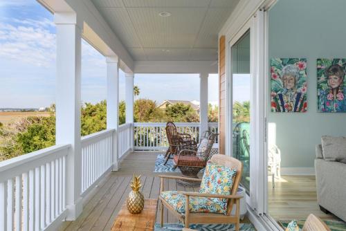 a porch with chairs and a view of the ocean at New Build, walking distance to pool and beach! Perfect location on Harbor Island! in Cedar Reef Villas