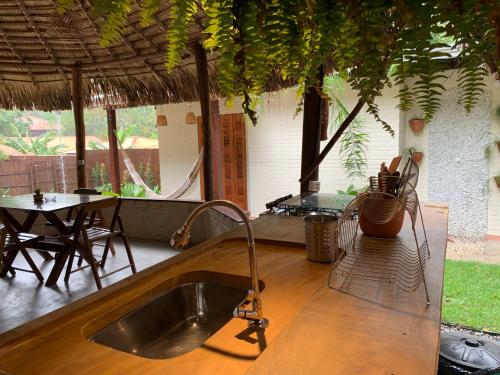a kitchen with a sink and a table with a tableablish at Recanto Alter do Chão in Alter do Chao