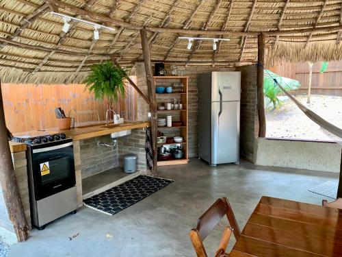a kitchen with a stove and a refrigerator in a room at Recanto Alter do Chão in Alter do Chao