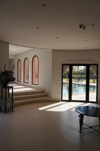 a room with a view of the water and a table at Villa Michel Lucas in Marrakesh