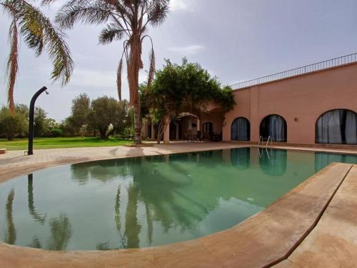 a swimming pool in front of a building at Villa Michel Lucas in Marrakesh