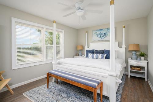 a bedroom with a white bed and a window at One Particular Harbor - Harbor Island Oceanfront, Private Pool! in Cedar Reef Villas