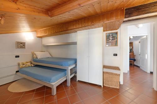 a room with two bunk beds and a wooden ceiling at Casa Marcone in Moneglia