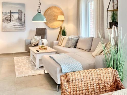 a living room with a couch and a table at Landhaus an der Nordsee mit Garten und Sauna! in Butjadingen