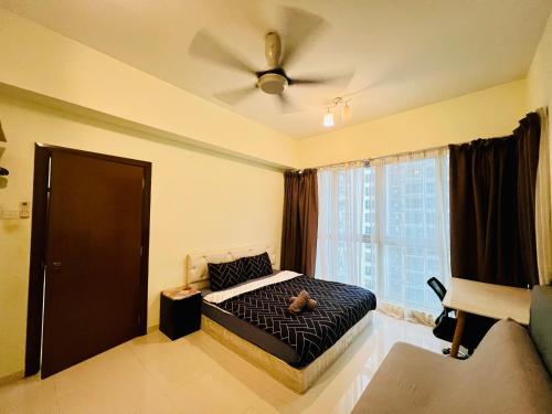 a bedroom with a bed and a ceiling fan at Regalia Spritz Empire Hostel in Kuala Lumpur