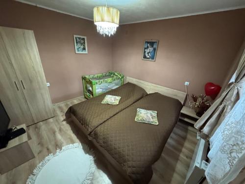 a bedroom with a bed with two pillows on it at Къща за гости Дени in Chukovezer