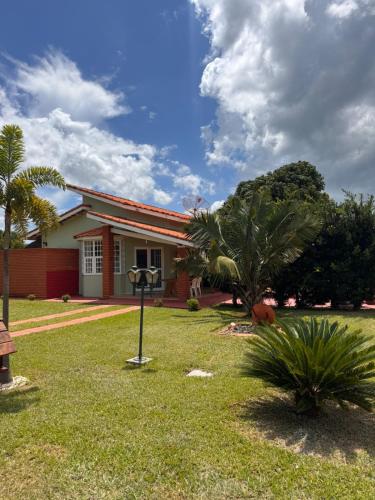 a house with palm trees in the yard at Riviera Santa Cristina l in Arandu