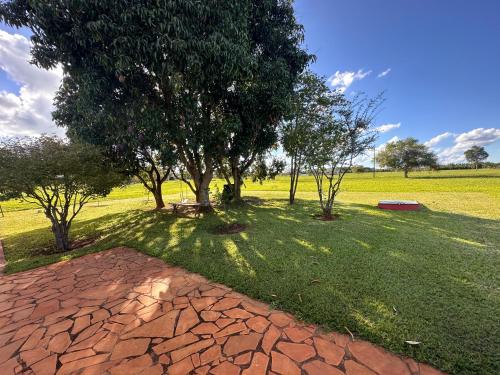 a park with a tree and a brick path at Riviera Santa Cristina l in Arandu