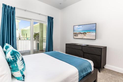a bedroom with a bed and a large window at Ocean Breeze Resort in NCA