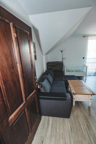 a living room with a couch and a table at wellness Chata u Pinkasů in Písečná
