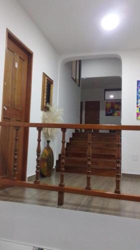 a room with a staircase with a vase and a mirror at Hotel Sarape in Medellín