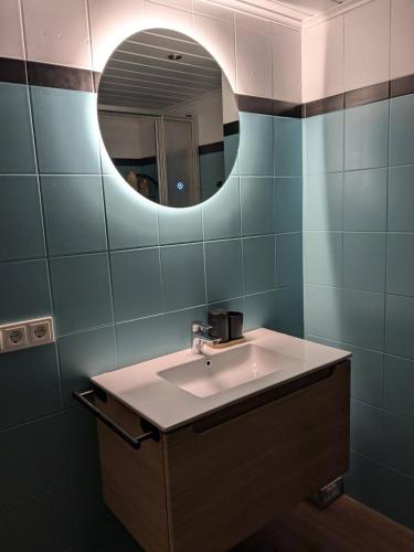 a bathroom with a sink and a mirror at Casita im Tal - Entspannung mit Terrasse, Garten und Garage in Weilburg