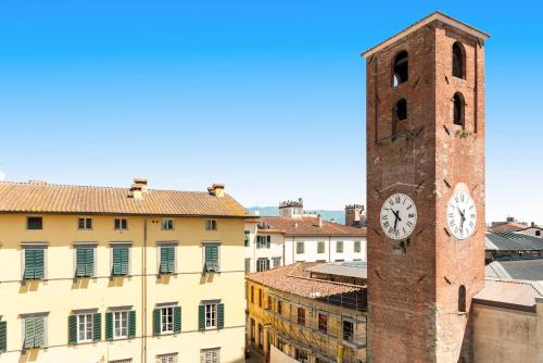 a tall tower with a clock on a building at Al Carmine Apartments Towers view with AC in Lucca