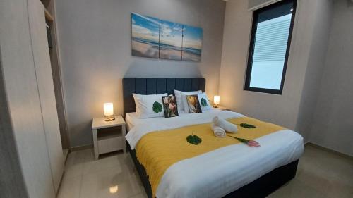 a bedroom with a large bed with two stuffed animals on it at LS Iconic Regency #Queensbay Mall#FIZ#Airport in Bayan Lepas