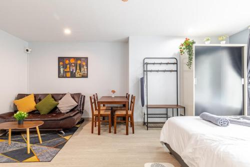 a bedroom with a bed and a table and a couch at Perfect 1BR at MRT Bangson By Orn in Bang Su