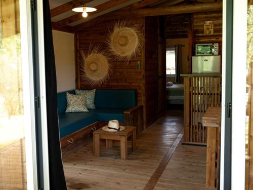 a living room with a blue couch and a table at Whaka Lodge in Seissan