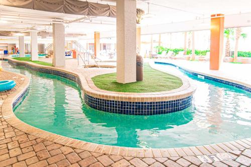 a swimming pool in a building with a pool at Tropical Suite at Oceanfront Resort w Lazy River in Myrtle Beach