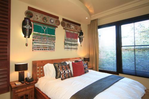 a bedroom with a bed and a window at AmmaZulu African Palace in Kloof