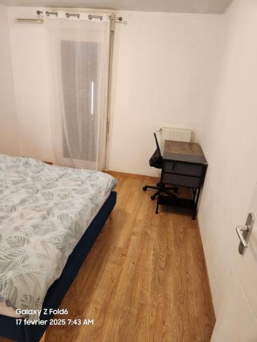 une chambre avec un lit et un bureau dans l'établissement Chic et simple avec parking à 5 min de la gare, à Nantes