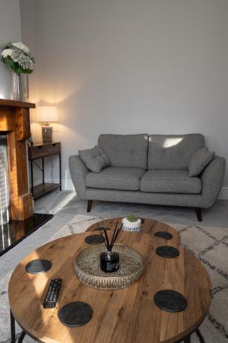 a living room with a couch and a coffee table at 4 Bed End Terrace - sleeps 7 in Ilkley
