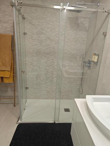 a bathroom with a shower and a sink at Suítes Lua in Castelo Branco