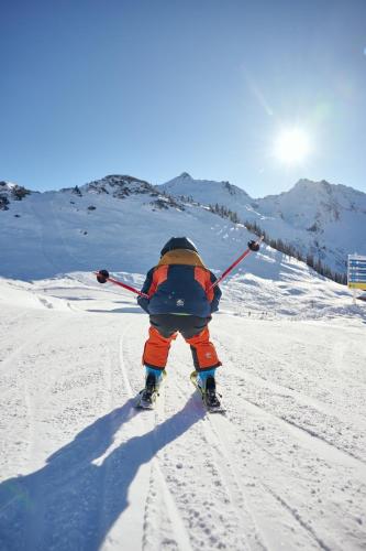 a person is skiing down a snow covered slope at Ferienwohnung Stelzis in Wald am Arlberg
