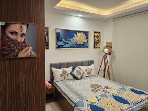a bedroom with a bed and a picture of a woman at Ultra Luxury 1Bhk 1121 Flat By Bliss Stay in Ghaggar