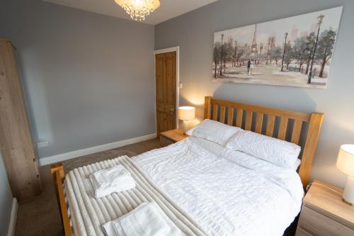 a bedroom with a bed with two towels on it at 4 Bed End Terrace - sleeps 7 in Ilkley