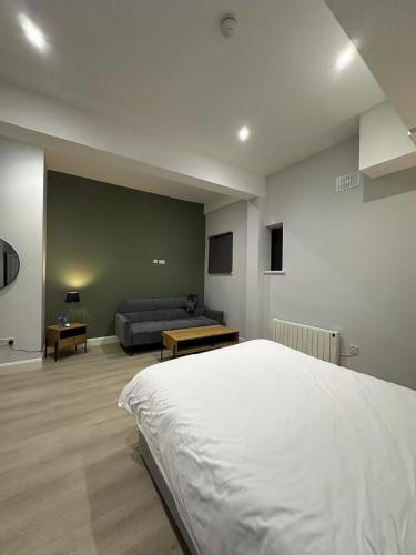 a bedroom with a large bed and a couch at Abbey Apartments in Dublin