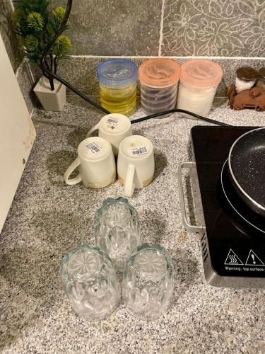 a counter top with glasses and other items on it at Beachfront Studios by Virani in Karachi