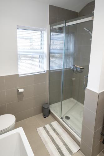 a bathroom with a shower and a toilet at 4 Bed End Terrace - sleeps 7 in Ilkley