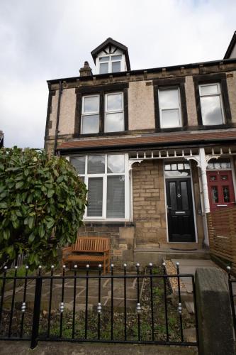 a house with a bench in front of it at 4 Bed End Terrace - sleeps 7 in Ilkley