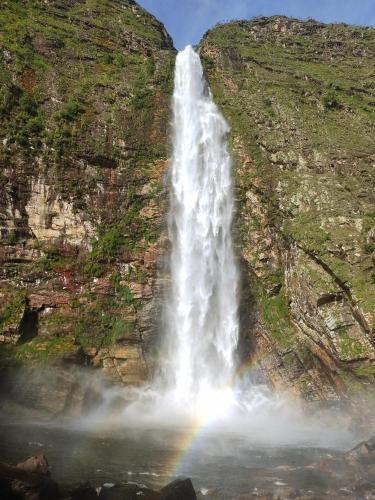 a rainbow at the end of a waterfall at Sons da Canastra Pousada e Terapias - em São José do Barreiro - São Roque de Minas MG in São Roque de Minas