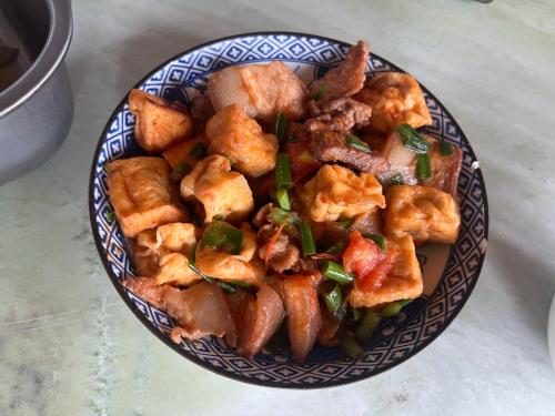 a blue and white plate of food on a table at Fish Farm Homestay in Yên Bái