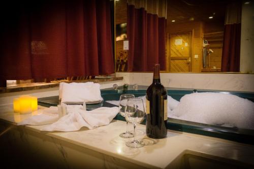 a bottle of wine sitting on a table with wine glasses at Postmarc Hotel and Spa Suites in South Lake Tahoe