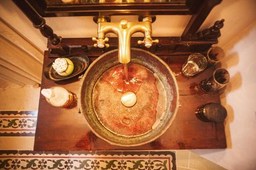 an overhead view of a bathroom sink with a faucet at Suites Li Curti, camere con piscina! in Ortelle