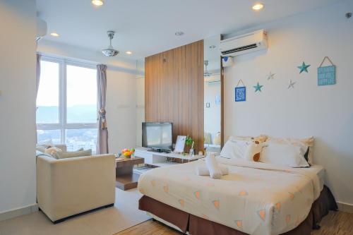 Un dormitorio con una cama y una silla y un televisor. en Mansion One l 4pax Studio l Cityview l Gleneagle l by PerfectSweetHome, en George Town