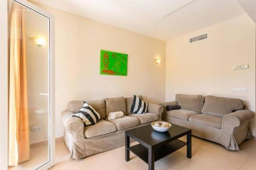 a living room with a couch and a table at Residence Club el Paraiso 37 in Sa Ràpita