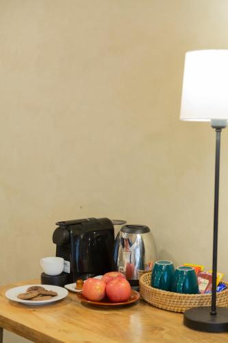 a table with a coffee pot and plates of fruit at Stone Hedge Hotel in Nubra