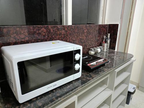 a microwave sitting on top of a counter at Yendluri's -StudioFlat-2 Kondapur, Gachibowli in Lingampalli