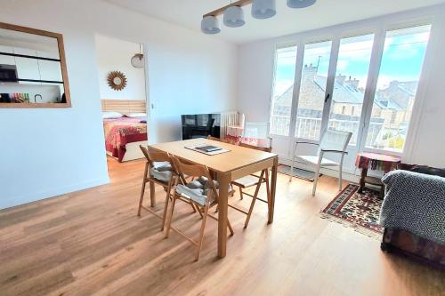 un salon avec une table et des chaises et une chambre dans l'établissement Very cozy apartment in the center of Paramé, à Saint-Malo