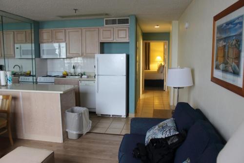 a kitchen and living room with a white refrigerator at Barclay Towers in Virginia Beach