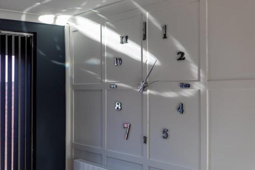 a room with white cabinets with numbers on them at Newly Refurbed Home With Football Table Near M5 Junction 2 in Oldbury