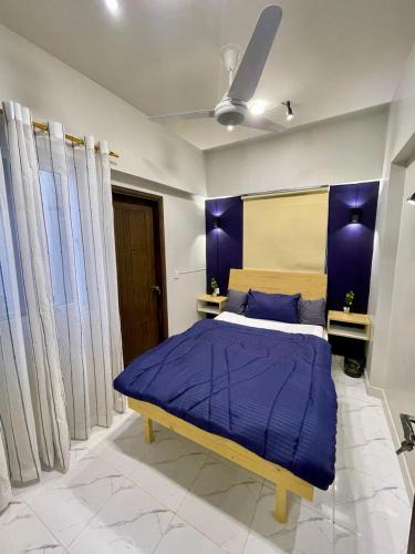 a bedroom with a large bed with purple walls at Beachfront Studios by Virani in Karachi