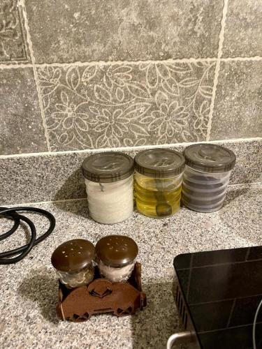 a group of three jars on top of a counter at Beachfront Studios by Virani in Karachi