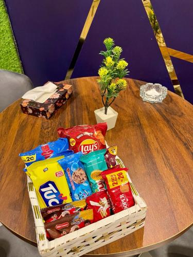 a table with a basket of chips and snacks at Beachfront Studios by Virani in Karachi