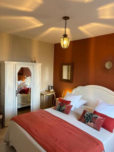 a bedroom with a large white bed with red pillows at L'Aghjalle in Santa-Reparata-di-Balagna