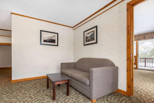 a living room with a couch and a table at Best Western Adirondack Inn in Lake Placid