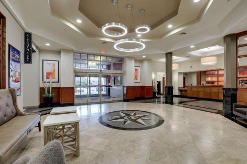 a lobby with a couch and a table at Drury Inn & Suites Charlotte Northlake in Charlotte